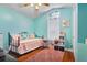 Cozy bedroom features a decorative window and a twin bed with colorful bedding at 7132 Colony Pointe Dr, Riverview, FL 33578