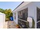 The exterior shows a screened porch and yard with tropical landscaping at 7132 Colony Pointe Dr, Riverview, FL 33578