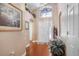 Bright foyer featuring gleaming wood floors, decorative plants, and a stained glass window over the front door at 7132 Colony Pointe Dr, Riverview, FL 33578