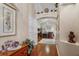 Entryway featuring hardwood floors, arched doorway, and decor above. View towards living room at 7132 Colony Pointe Dr, Riverview, FL 33578