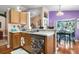 Kitchen area featuring wood cabinets, breakfast bar, and view into the dining room at 7132 Colony Pointe Dr, Riverview, FL 33578