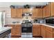 Kitchen with stainless steel range, wood cabinets, and ample countertop space at 7132 Colony Pointe Dr, Riverview, FL 33578