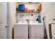 Functional laundry room features a washer and dryer, plus storage shelves at 7132 Colony Pointe Dr, Riverview, FL 33578