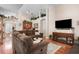 Open-concept living room with hardwood floors, cozy seating, and a fireplace at 7132 Colony Pointe Dr, Riverview, FL 33578