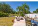 Spacious backyard patio with ample seating, a fire pit, and lush landscaping at 7132 Colony Pointe Dr, Riverview, FL 33578
