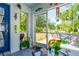 View of the screened porch with a table and chairs overlooking a lovely, spacious backyard area at 7132 Colony Pointe Dr, Riverview, FL 33578