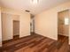 Comfortable bedroom with wood floors, closet, and access to the bathroom at 8221 12Th N Way # F, St Petersburg, FL 33702