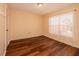 Cozy bedroom featuring wood floors and natural light from a window at 8221 12Th N Way # F, St Petersburg, FL 33702
