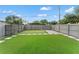 View of the artificial turf, fenced yard, and the surrounding neighborhood at 921 W Coral St, Tampa, FL 33602