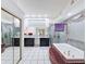 Bathroom featuring a tiled tub, a glass-enclosed shower, and double vanities at 9253 Water Hazard Dr, Hudson, FL 34667