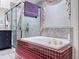 Bathroom featuring a tiled tub and a glass-enclosed shower with a hand towel at 9253 Water Hazard Dr, Hudson, FL 34667