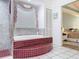 Bathroom featuring a tiled tub and a glass-enclosed shower at 9253 Water Hazard Dr, Hudson, FL 34667
