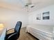 Bedroom with wood floors, ceiling fan, and two landscape pictures at 9253 Water Hazard Dr, Hudson, FL 34667