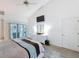 Bright bedroom featuring a ceiling fan, television, and sliding glass doors leading to the pool area at 9253 Water Hazard Dr, Hudson, FL 34667