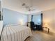 Bedroom with wood floors, ceiling fan, window and a desk at 9253 Water Hazard Dr, Hudson, FL 34667