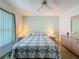 Bedroom featuring a comfy bed, wood floor, and window allowing for natural light at 9253 Water Hazard Dr, Hudson, FL 34667