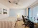 Bedroom with wood floors, ceiling fan, window and a desk at 9253 Water Hazard Dr, Hudson, FL 34667
