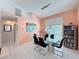 Light and airy dining area with a glass-topped table, tile flooring, and modern decor at 9253 Water Hazard Dr, Hudson, FL 34667