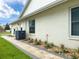 Home's exterior with neat landscaping, showing pavers, rock and plants at 9253 Water Hazard Dr, Hudson, FL 34667