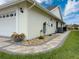 Exterior of the house showing a well-maintained paver walkway and meticulous landscaping at 9253 Water Hazard Dr, Hudson, FL 34667