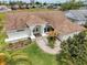Beautiful home boasts lush landscaping and a covered front entry, creating a welcoming curb appeal at 9253 Water Hazard Dr, Hudson, FL 34667