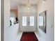 Bright foyer with tile flooring, a crystal chandelier and decorative accents at 9253 Water Hazard Dr, Hudson, FL 34667