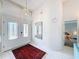 Bright foyer featuring high ceilings, tile flooring, and decorative lighting with a red rug at 9253 Water Hazard Dr, Hudson, FL 34667