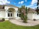 Exterior view of the house showcasing a front patio with table and chairs at 9253 Water Hazard Dr, Hudson, FL 34667