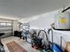Functional garage space with organized storage shelves, work bench, and a convenient water heater setup at 9253 Water Hazard Dr, Hudson, FL 34667