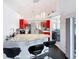 Bright kitchen features stainless steel appliances, modern red cabinets, granite countertops and barstool seating at 9253 Water Hazard Dr, Hudson, FL 34667