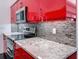 Close up of granite countertop, backsplash, and stainless steel oven at 9253 Water Hazard Dr, Hudson, FL 34667