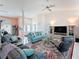 Open living room with tile floors, comfortable seating, and a large entertainment center at 9253 Water Hazard Dr, Hudson, FL 34667