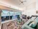 Comfortable living room with tile floors, high ceilings, and sliding glass doors to the lanai at 9253 Water Hazard Dr, Hudson, FL 34667
