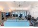 Spacious living room with modern furniture, ceiling fan, and view of the pool area at 9253 Water Hazard Dr, Hudson, FL 34667