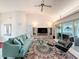 Bright living room featuring tile floors, vaulted ceiling, and a decorative rug with seating at 9253 Water Hazard Dr, Hudson, FL 34667
