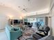 Bright living room with vaulted ceilings, tile flooring, and sliding glass doors to the outdoor pool area at 9253 Water Hazard Dr, Hudson, FL 34667