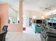 Bright living room with tile floors, high ceilings, and an open view of the dining area at 9253 Water Hazard Dr, Hudson, FL 34667