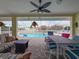 Inviting pool area with covered lanai, outdoor seating, and well-maintained landscaping at 9253 Water Hazard Dr, Hudson, FL 34667
