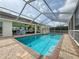 Spacious backyard with screened in pool, patio for lounge chairs and outdoor entertainment at 9253 Water Hazard Dr, Hudson, FL 34667
