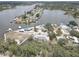 Beautiful aerial view of waterfront home and neighborhood with mature trees, docks and bay access at 9914 Alavista Dr, Gibsonton, FL 33534