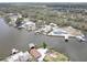 Wide aerial capture of waterfront homes with docks, immersed in the river's calming waters and rich foliage at 9914 Alavista Dr, Gibsonton, FL 33534