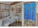 Unique bathroom featuring nautical decorations, a farmhouse sink and a colorful shower curtain at 9914 Alavista Dr, Gibsonton, FL 33534