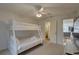 Bedroom with a bunk bed, TV, carpet, and bathroom access at 9914 Alavista Dr, Gibsonton, FL 33534
