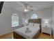 Charming bedroom featuring a queen size bed, wood floors, and dual windows at 9914 Alavista Dr, Gibsonton, FL 33534