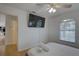 Bright bedroom features a ceiling fan, flat screen tv and ensuite bathroom at 9914 Alavista Dr, Gibsonton, FL 33534