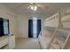 Bedroom with a bunk bed, window, flatscreen tv, and ceiling fan at 9914 Alavista Dr, Gibsonton, FL 33534