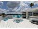 Inviting waterfront deck with stylish patio furniture, a hot tub, and stunning views at 9914 Alavista Dr, Gibsonton, FL 33534