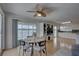 Cozy dining area with water view, modern furniture, and open access to kitchen and living room at 9914 Alavista Dr, Gibsonton, FL 33534