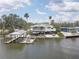 Waterfront home on stilts with dock, boat lift, solar panels, and wrap around deck at 9914 Alavista Dr, Gibsonton, FL 33534