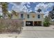 Charming two-story home with a two car garage, coastal landscaping and a driveway to the street at 9914 Alavista Dr, Gibsonton, FL 33534